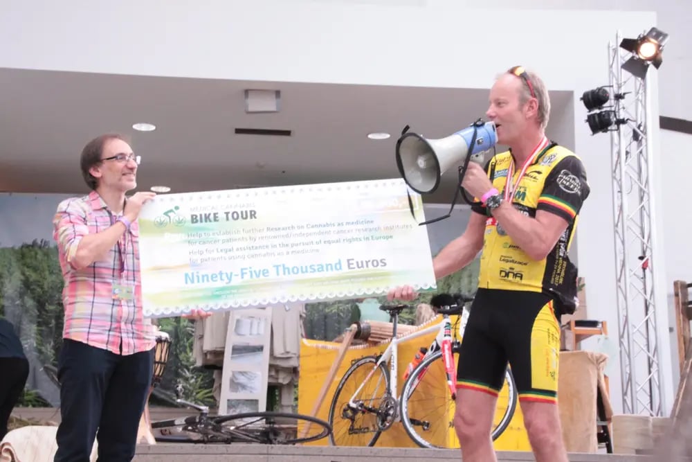 Luc Krol hands Dr Guillermo Velasco a charity check for scientific research 